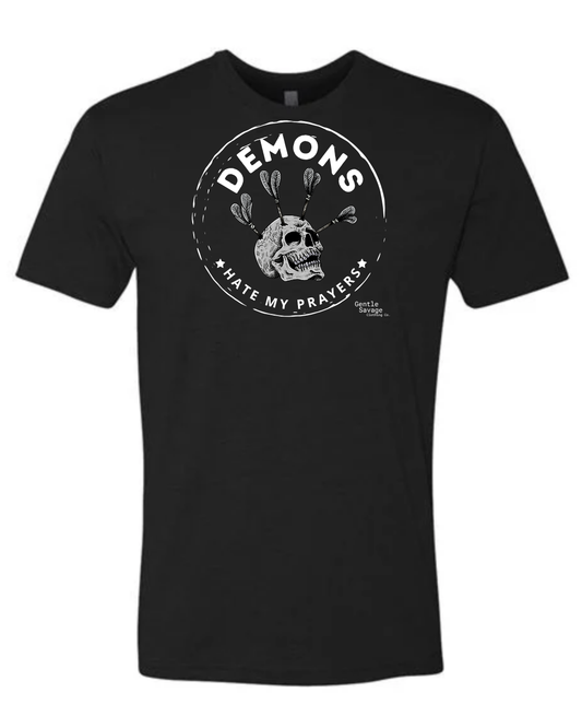 Black t-shirt with white graphic design on a white background Skull with arrows in skull Demons Hate My Prayers