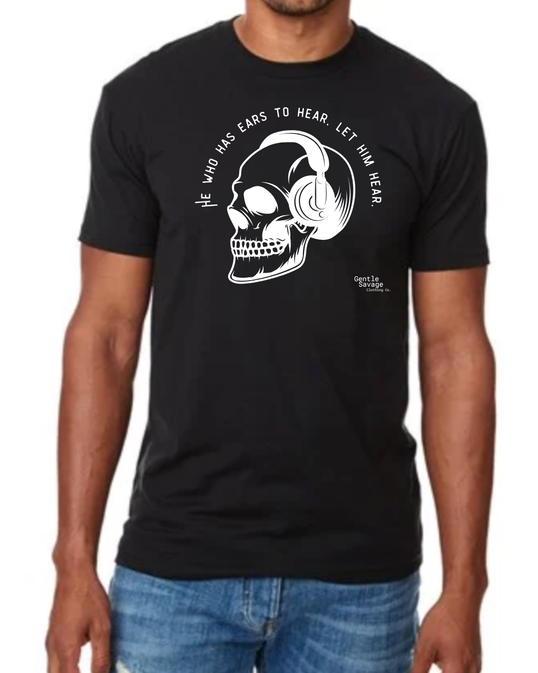 Black t-shirt with a skull and headphones design and text worn by a person.